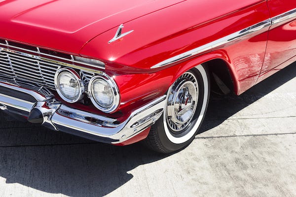 Vintage, red car parked on the street