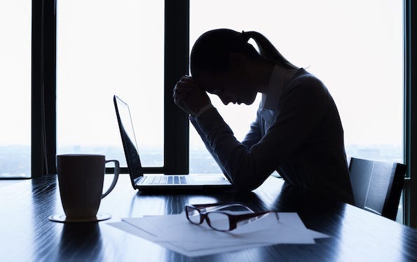 Stressed businesswoman sitting at desk