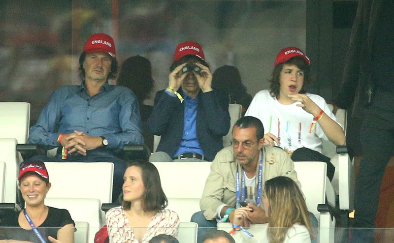 mick jagger uses binoculars at soccer game