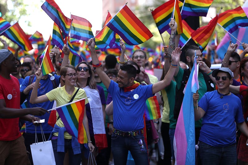 Parade participants wave pride flags as the march during the 2016 San Francisco Pride Parade on June 26, 2016 in San Francisco, California.