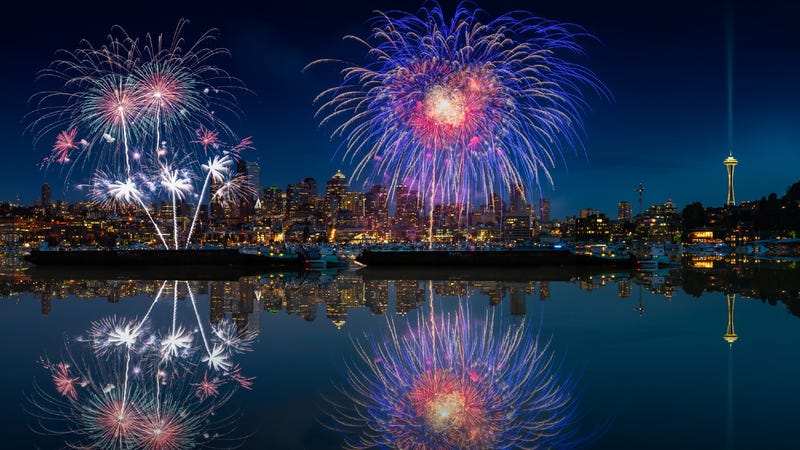 July 4th fireworks exploding in the sky over Lake Union with the Seattle skyline in the background