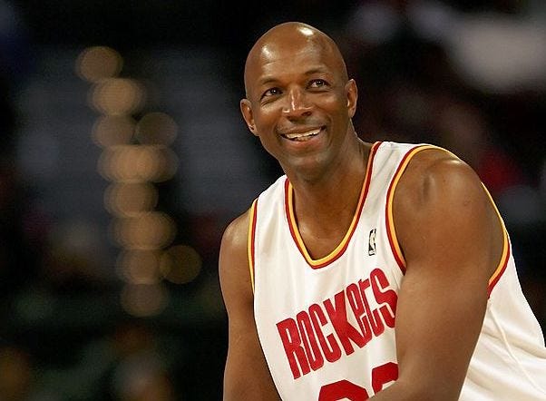 Clyde Drexler smiles during a game.