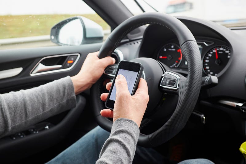 A driver using a cell phone.
