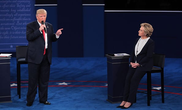 Republican presidential nominee Donald Trump (L) speaks as Democratic presidential nominee former Secretary of State Hillary Clinton