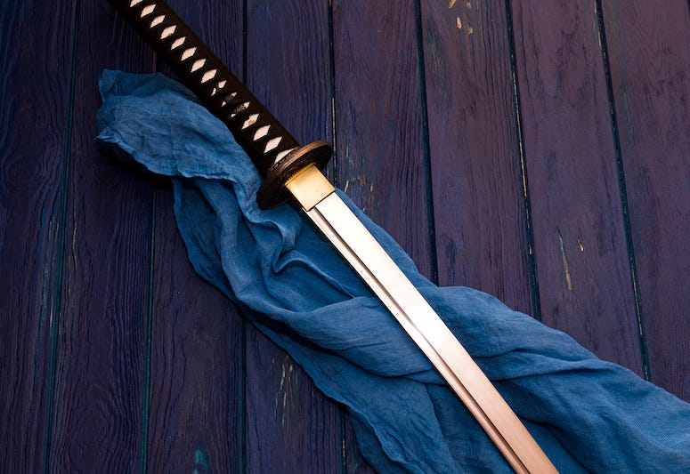 Samurai sword on wooden table