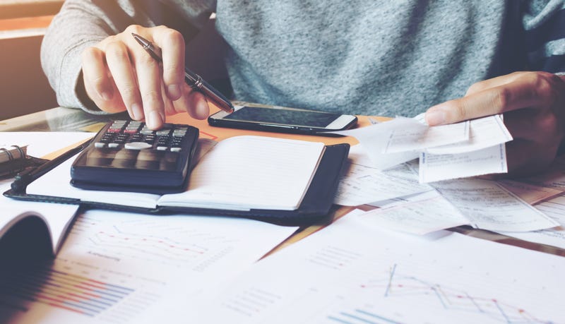 Man using calculator to calculate budget