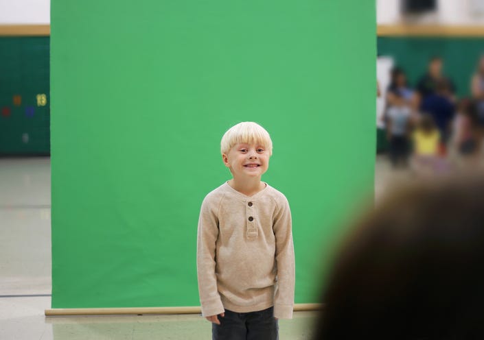 Child getting his photo taken for school.