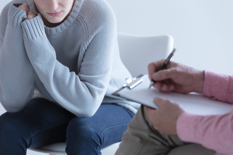 Young girl during session with her psychotherapist.