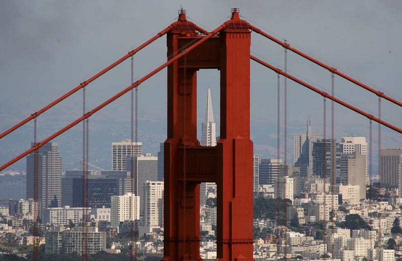 The Transamerica Pyramid building is seen through the north tower of the Golden Gate Bridge June 20, 2007 as seen from Sausalito, California.