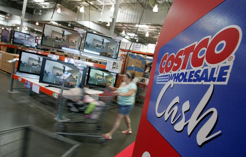 woman shopping for tvs using costco cash