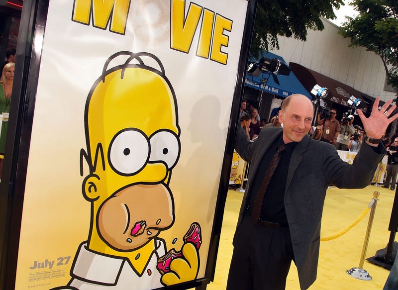 Dan Castellaneta with the poster for "The Simpsons Movie"