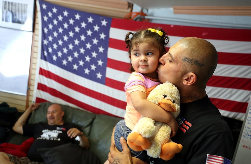 Deported U.S. Marine Corp veteran Mauricio Hernandez, who served in Afghanistan, kisses his daughter Emily Hernandez as he visits the Deported Veterans Support House on July 4, 2017 in Tijuana, Mexico. The Deported Veterans Support House, also known as "The Bunker" was founded by deported U.S. Army veteran Hector Barajas to support deported veterans by offering food, shelter, clothing as well as advocating for political legislation that would prohibit future deportations of veterans. There are an estimated 11,000 non-citizens serving in the U.S. military and most will be naturalized during or following their service. Those who leave the military early or who are convicted of a crime after serving can be deported. (Photo by Justin Sullivan/Getty Images)