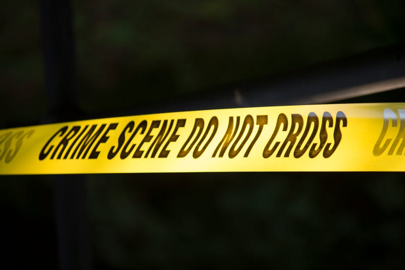 A photo of crime scene tape on a near black background