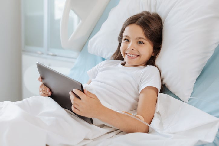 Cheerful elated girl using modern technology