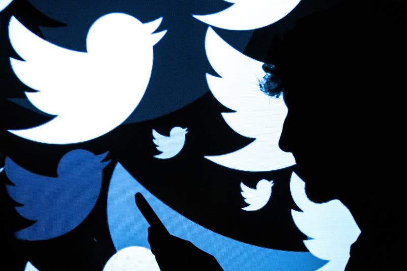 In this photo illustration, the logo for the Twitter social media network is projected onto a man on August 09, 2017 in London, England
