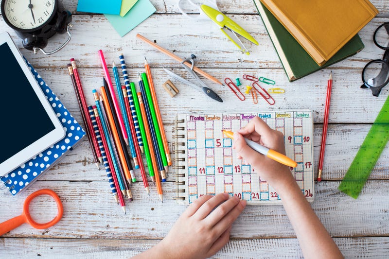 girl writing in calendar or planner