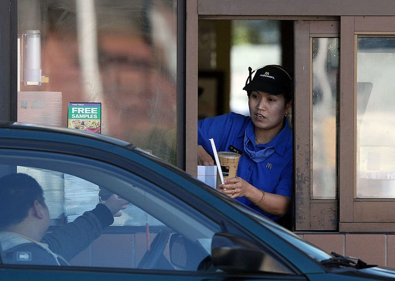 A McDonald's drive thru worker hands an order to a customer February 9, 2009 in San Francisco, California.