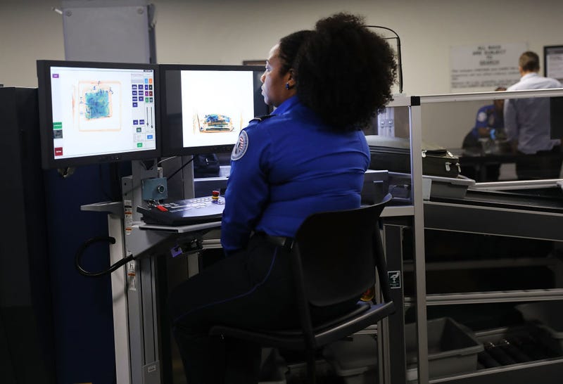 A Transportation Security Administration (TSA) worker screens luggage at LaGuardia Airport.