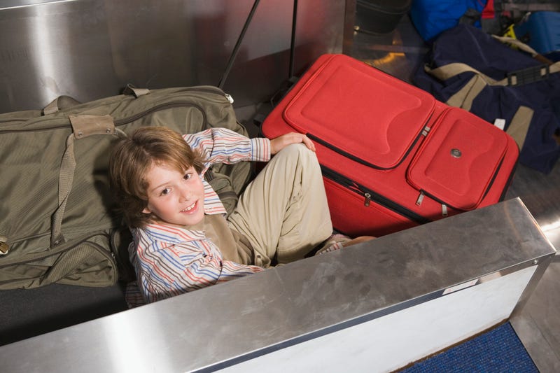 Boy on Baggage Conveyor Belt