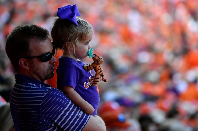Father and daughter attend a game