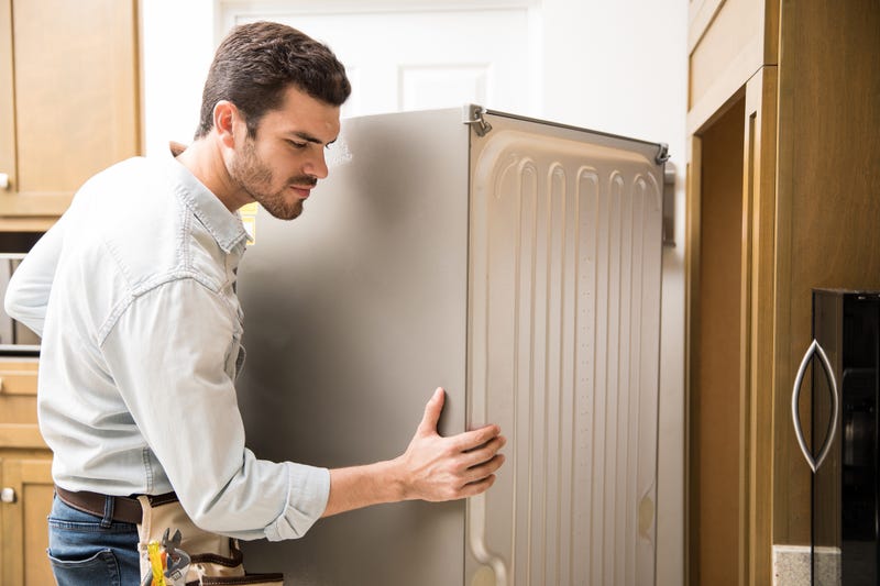 A man moves a refrigerator