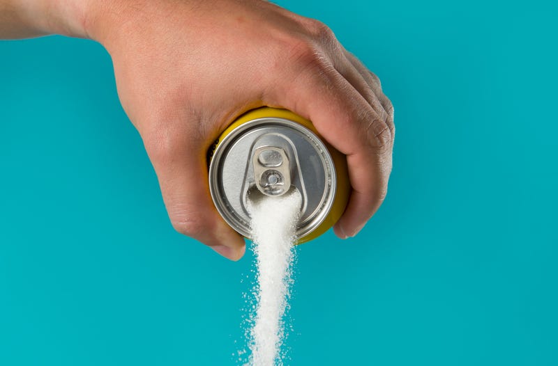 man hand holding lemon refresh drink can pouring sugar stream in sweet and calories content of soda and energy drinks