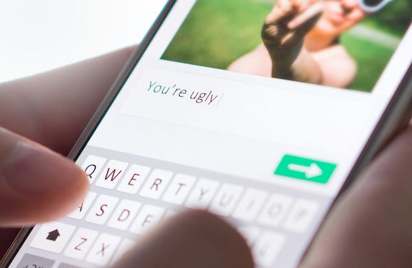 Internet troll typing mean comment