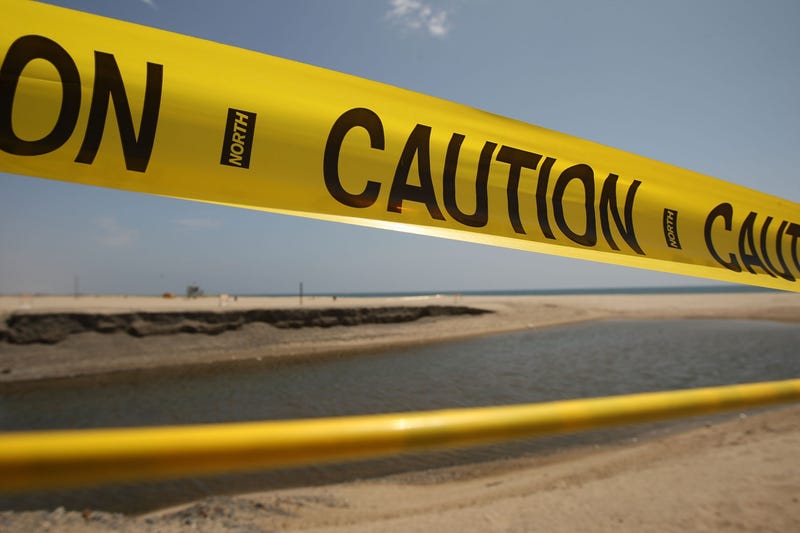 A barrier of caution tape warns beach-goers to stay out of the water, which is polluted by run-off from a nearby storm drain and creek, at Will Rogers State Beach on May 22, 2009 in Pacific Palisades, California