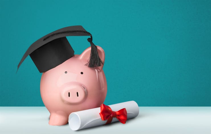 Piggy bank with diploma and graduation cap
