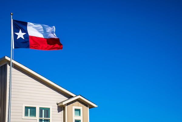 Texas flag flying over house