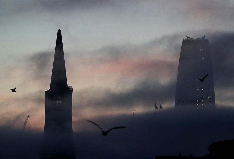 The Transamerica Pyramid and Salesforce Tower peek through light fog on January 31, 2018 in San Francisco, California.