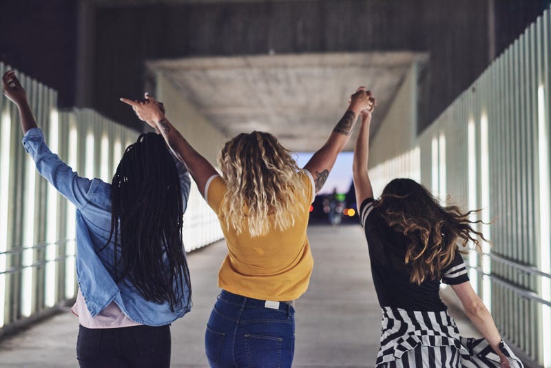 women walking hand in hand