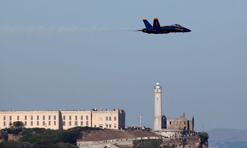 A U.S. Navy Blue Angels F/A-18 Hornet passes over Alcatraz Prison during a practice performance ahead of the Fleet Week air show October 9, 2009 in San Francisco, California.