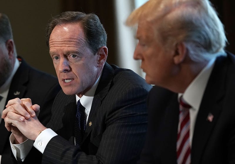 Sen. Pat Toomey (left) speaks as President Donald Trump listens during a meeting with congressional members in the Cabinet Room of the White House February 13, 2018 in Washington, D.C.