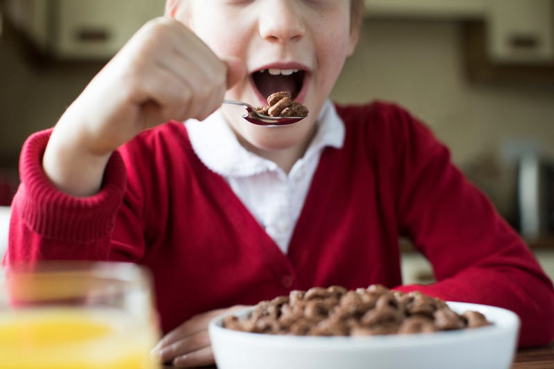 boy eats cereal for breakfast