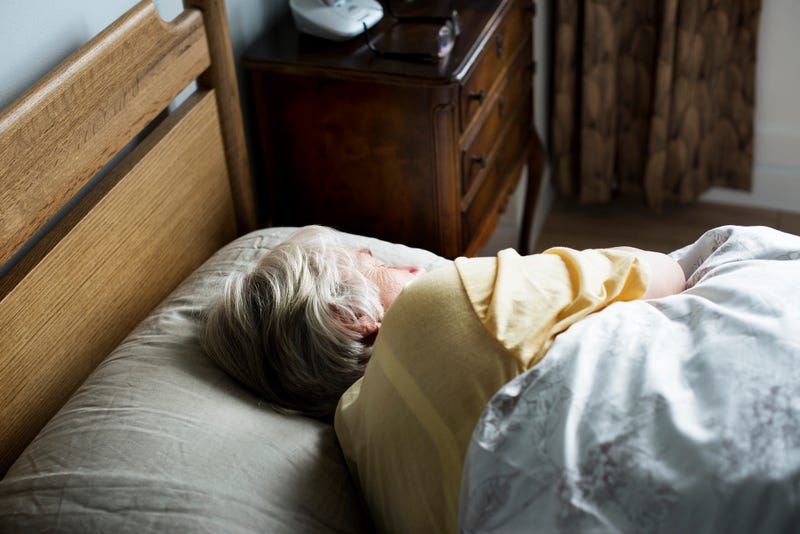 Elderly woman napping stock photo.