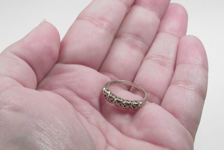 Woman holding a ring in her palm