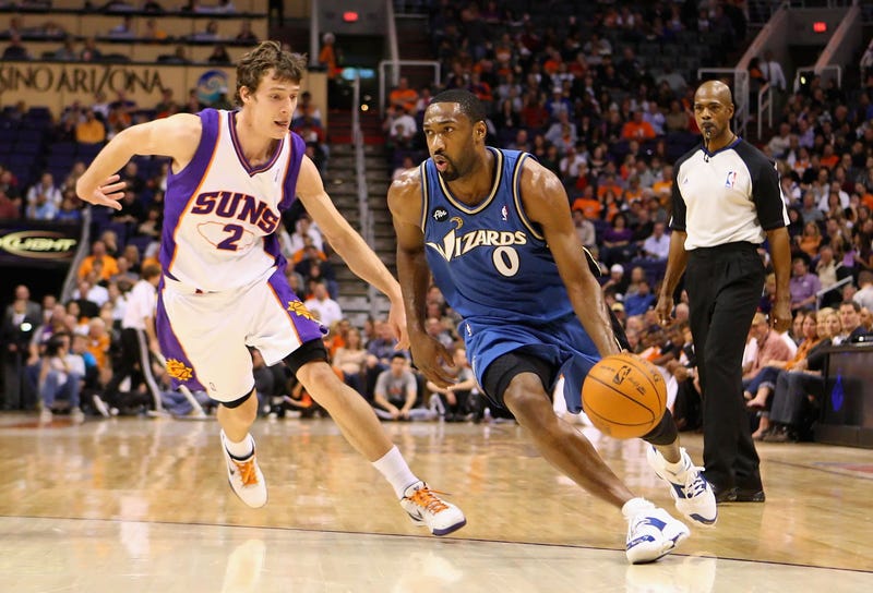 Gilbert Arenas driving on Phoenix Suns guard Goran Dragic