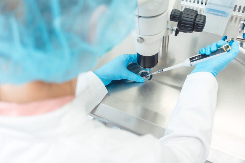 Scientist working with pipette in laboratory.