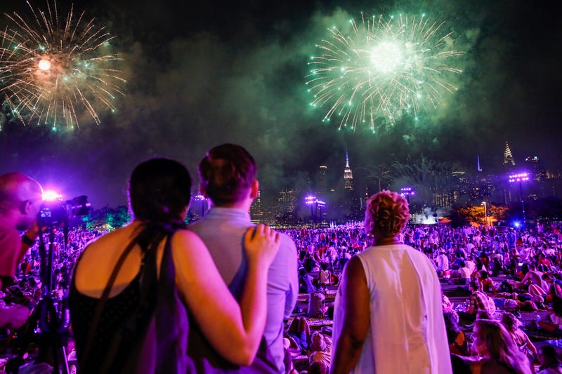 People watch the Macy's Fourth of July Fireworks from Hunter Point Park on July 4, 2018 in New York City