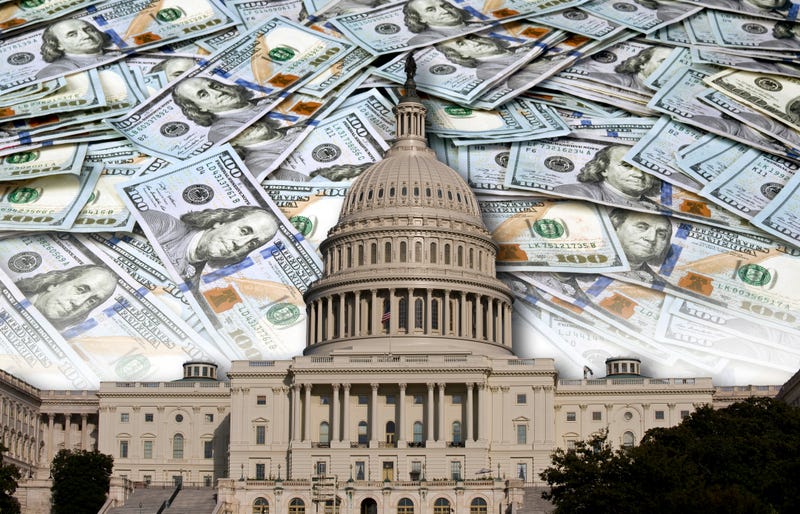 $100 bills with the US Capitol in the foreground