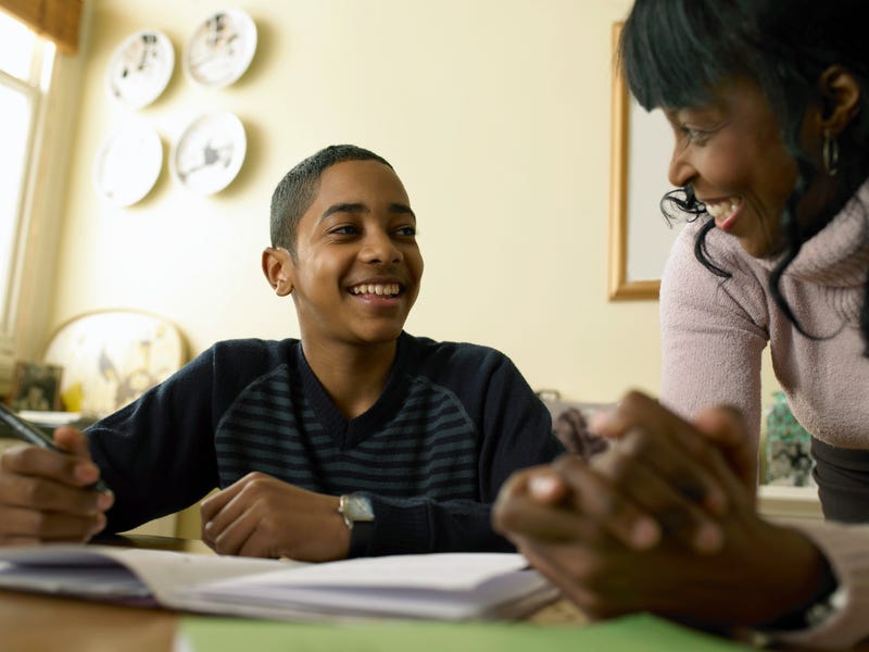 A mother and son work together on his homework