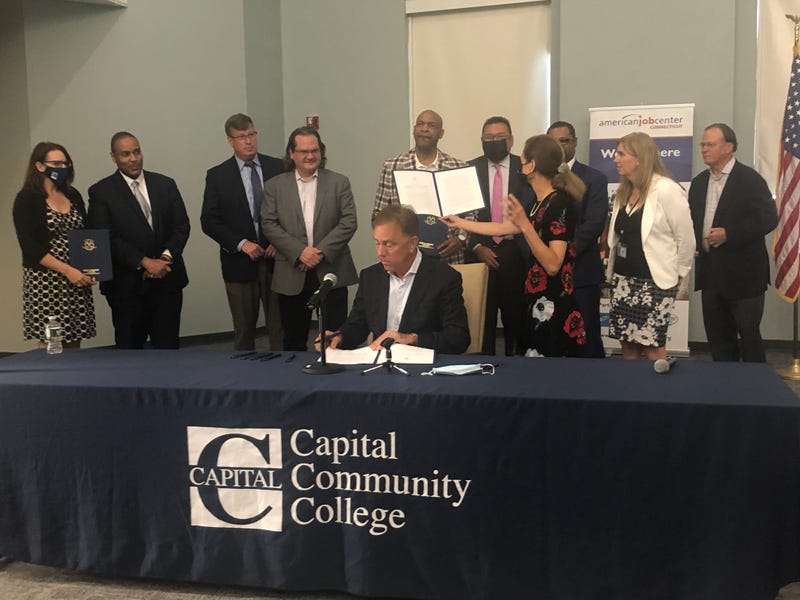 Governor Ned Lamont signs bill at Capital Community College