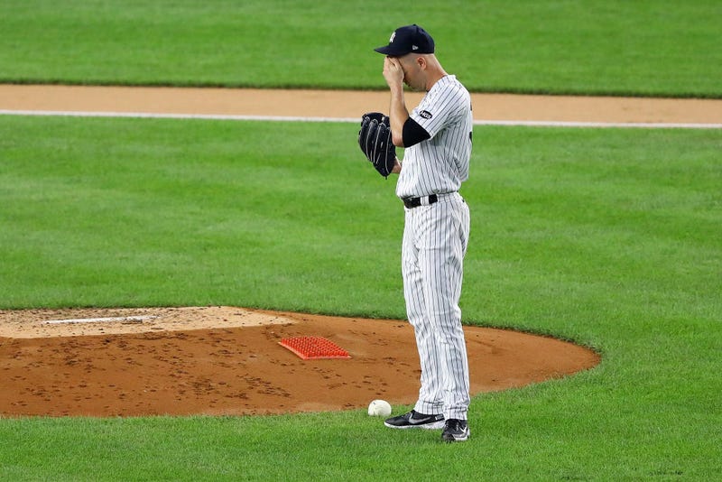 JA Happ wipes his face during a Yankees game vs. the Red Sox.