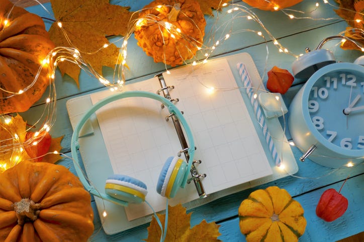 headphones on a planner with lights and pumpkins