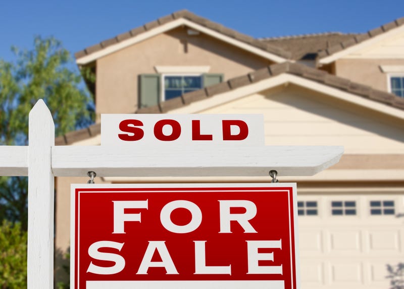 A "sold" sign signifying an agreement to buy a home