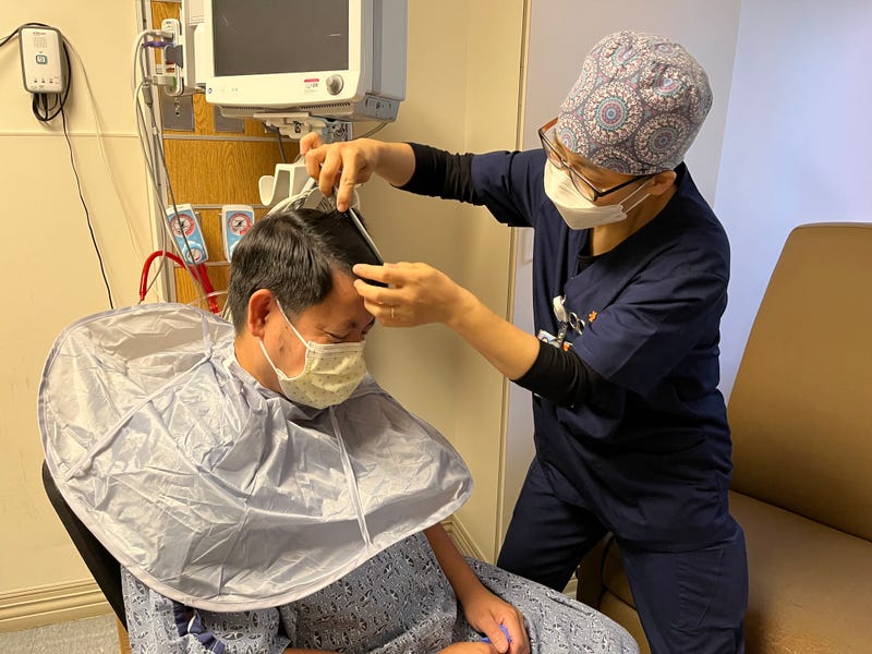 Ju Young Jung, Critical Care Nurse at Dignity Health - California Hospital Medical Center, cuts the hair of one of her colleagues during a break