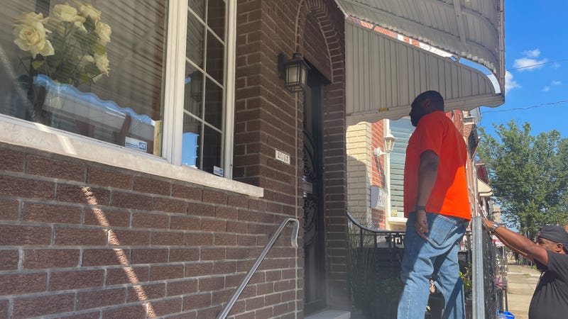 Councilmember Kenyatta Johnson at a resident's door in Point Breeze. Two people were shot and killed within six blocks of each other in a four-day period.