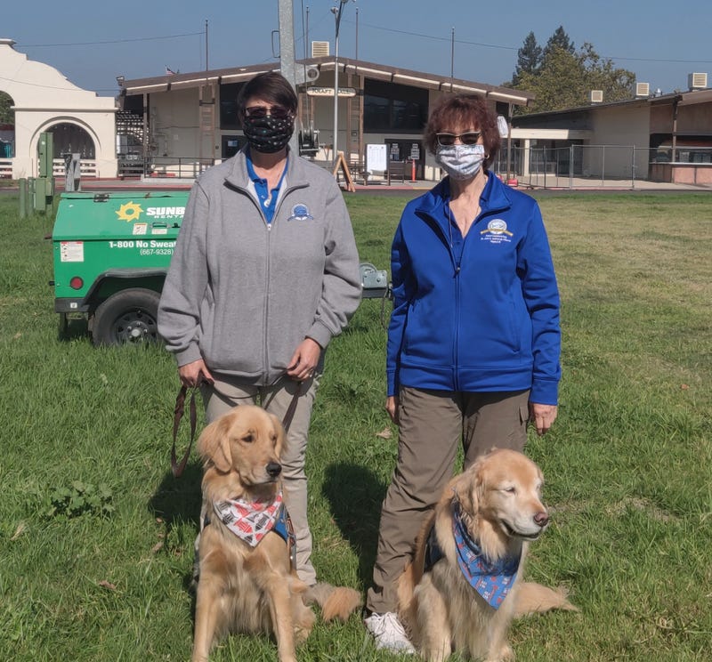 Linda Melsheimer with Micha (left) and Marilyn Hunter with Aaron (right) visiting firefighters at CAL FIRE base camp in Santa Rosa.