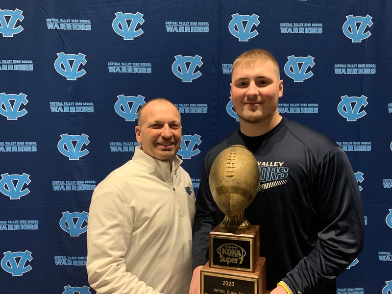 Central Valley head coach Mark Lyons (L) and defensive lineman Sean FitzSimmons (R) pose with Sean's 3A KDKA Radio Super 7 Player of the Year trophy.